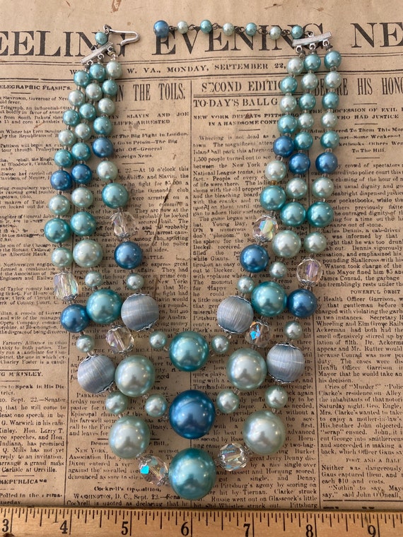 Multi-strand blue beaded necklace.