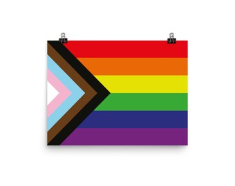 May include: A pride flag with a black, brown, light blue, and pink triangle in the top left corner. The rest of the flag is a rainbow with red, orange, yellow, green, blue, and purple stripes.