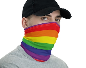 May include: A person wearing a black baseball cap and a face covering with a rainbow pattern. The face covering is a multi-colored neck gaiter with red, orange, yellow, green, blue, indigo, and violet stripes.