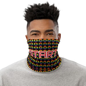 May include: A black face mask with a rainbow pattern of arrows and the word "START" in red letters.