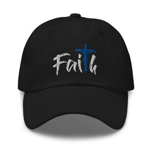 May include: Black baseball cap with white embroidered text that says "Faith" and a blue embroidered cross with a figure on it.