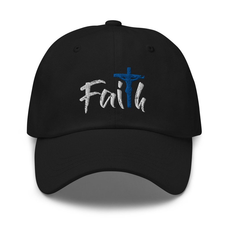 May include: Black baseball cap with white embroidered text that says "Faith" and a blue embroidered cross with a figure on it.