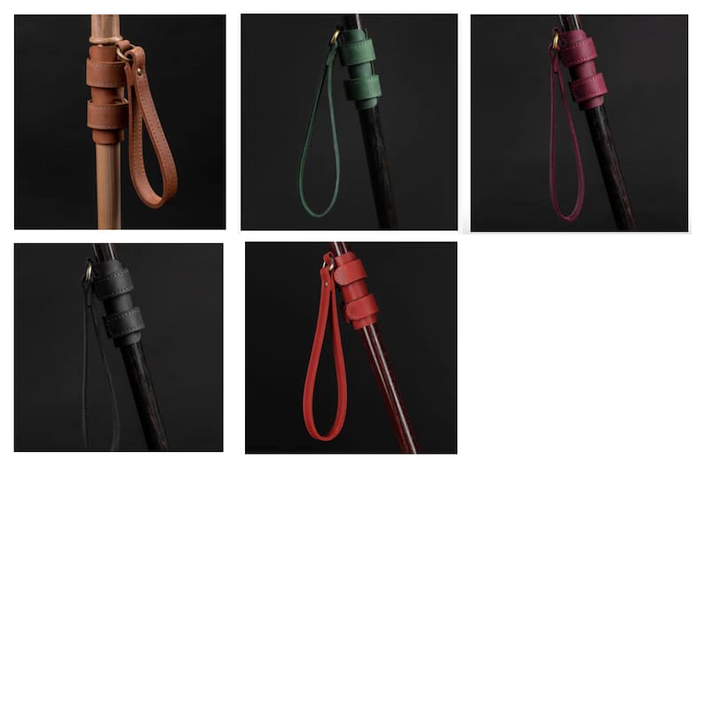 May include: Five leather wrist straps in different colors, each attached to a wooden walking stick. The straps are brown, green, red, black, and burgundy.