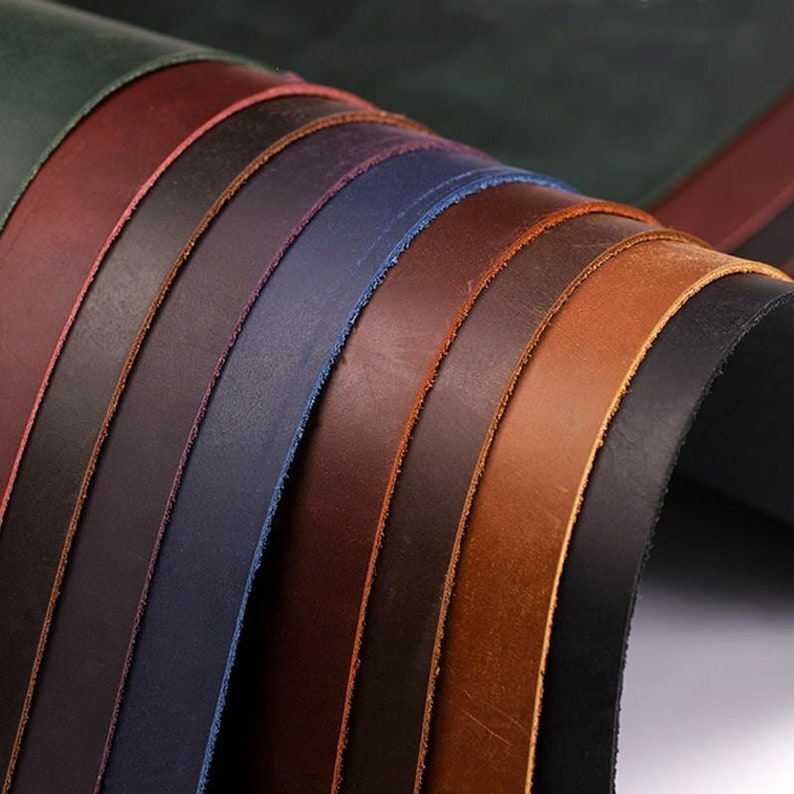 May include: A variety of leather strips in different colors, including brown, tan, blue, and green. The strips are arranged in a fan shape, with the darkest color at the bottom and the lightest color at the top.