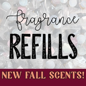 May include: A collection of small, clear plastic bags containing fragrance oil samples, each with a circular label. The text "fragrance REFILLS" is overlaid in black, and a dark red banner at the bottom displays "NEW FALL SCENTS!" in peach.