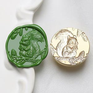 May include: Two wax seals, one green and one gold, with a detailed design of a squirrel holding a nut in a forest setting.