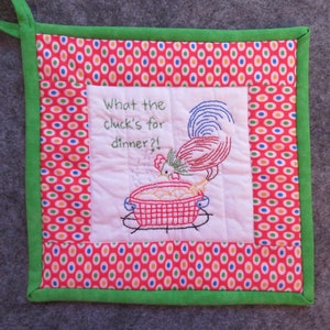 May include: Embroidered kitchen potholder with a red, white, and blue rooster design. The potholder has a red background with white, blue, and green polka dots. The text "What the cluck's for dinner?!" is embroidered on the white center.