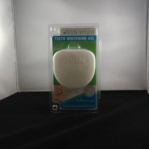 May include: A white plastic tray with a clear plastic lid containing a white teeth whitening gel. The tray is labeled "VIN White Teeth Whitening Gel" and "5.0 ml Syringe".
