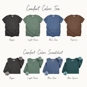 a collection of t-shirts in various colors, including black, green, blue, brown, light green, blue jeans, and blue spruces.
