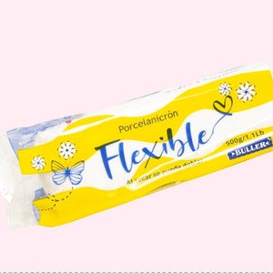 May include: A yellow and white package of flexible porcelain paper towels. The package features a butterfly, flowers, and the text "Porcelanicrón Flexible" and "500g/1.1Lb BULLER".