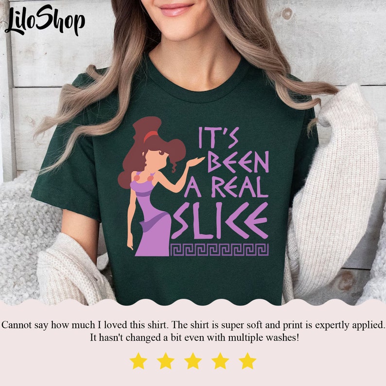 May include: Green t-shirt with a purple cartoon character and the text "It's Been A Real Slice" in a Greek font.