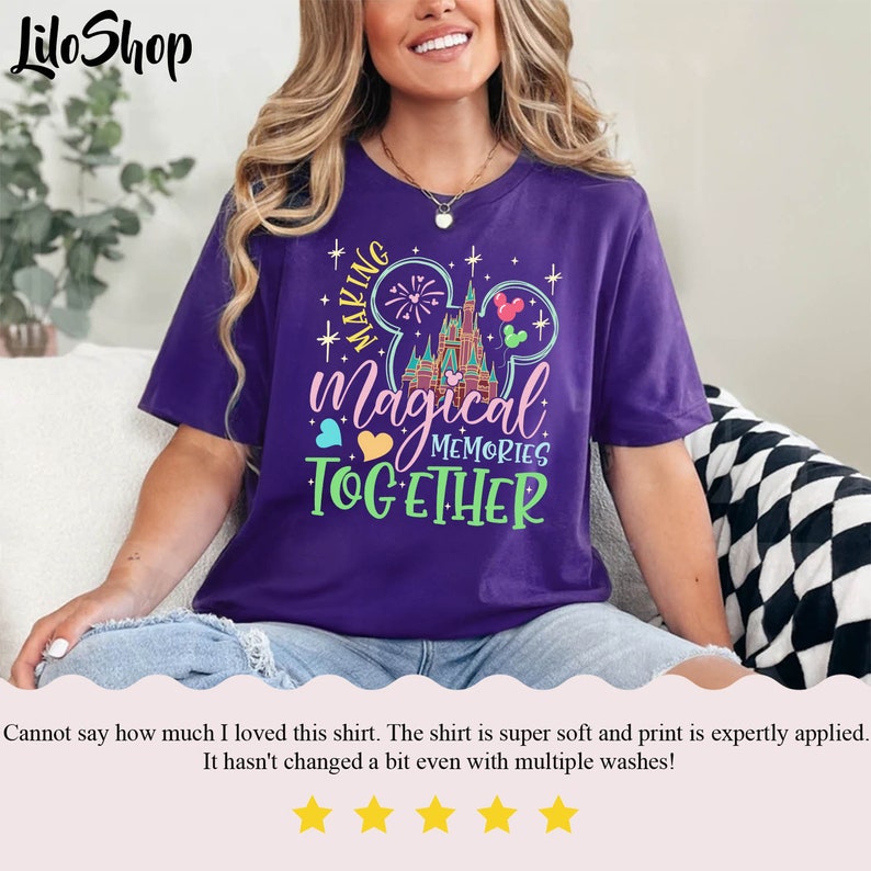 May include: Purple t-shirt with a graphic of Mickey Mouse ears, the Disney castle, and the text "Making Magical Memories Together".