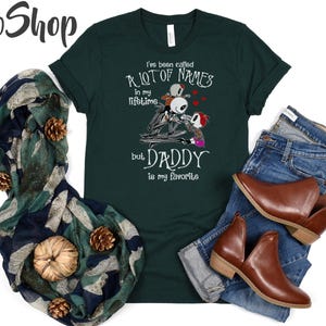 May include: Green t-shirt with a graphic of three skeleton figures and the text "I've been called a lot of names in my lifetime but Daddy is my favorite".