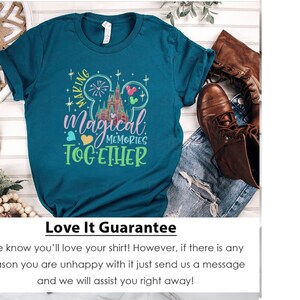 May include: Teal blue t-shirt with a graphic of the Cinderella's Castle at Walt Disney World, fireworks, Mickey Mouse ears, and the text "Making Magical Memories Together".