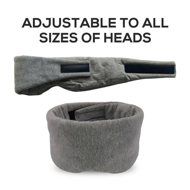 May include: Gray sleep mask with adjustable strap. The mask is made of soft, comfortable fabric and is designed to block out light.  "ADJUSTABLE TO ALL SIZES OF HEADS" is written in black text at the top of the image.