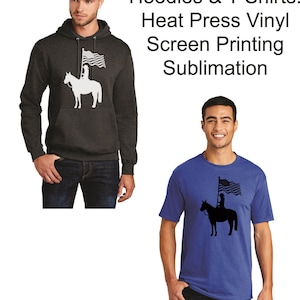May include: Two men are wearing a dark gray hoodie and a royal blue t-shirt. Both shirts feature a black silhouette of a person riding a horse holding a flag. The text "Hoodies & T Shirts! Heat Press Vinyl Screen Printing Sublimation" is displayed above the men.