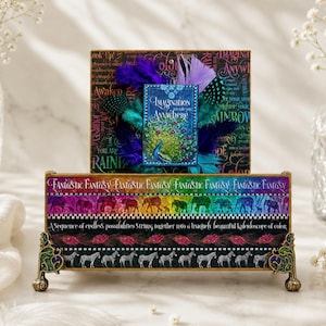 May include: A decorative box with a peacock illustration and the words "Imagination Anywhere." The box features a rainbow design with elephants and zebras. The text "Fantastic Fantasy" is visible. The box is supported by ornate gold-colored legs.