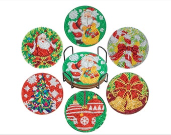 May include: Set of six round Christmas coasters with festive designs, including Santa Claus, Christmas tree, ornaments, and bells. The coasters are embellished with colorful beads and come with a black metal holder.