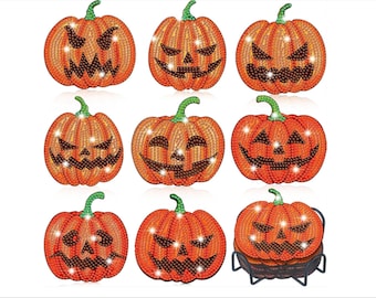 May include: Nine orange pumpkin coasters with various carved faces and green stems. The coasters are decorated with sparkling embellishments, perfect for Halloween or fall decor. One set of coasters is in a black metal holder.