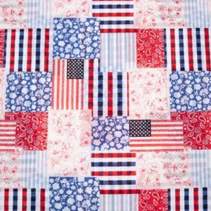 May include: A patchwork fabric design featuring squares with patriotic patterns. The squares include American flags, floral prints, paisley, and striped patterns in red, white, and blue. The fabric is suitable for quilting and crafting.