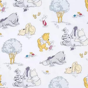 May include: A white fabric with a repeating pattern of Winnie the Pooh and his friends. The characters include Winnie the Pooh, Piglet, Tigger, and Eeyore. The characters are depicted in various poses, including standing, sitting, and playing. The fabric is perfect for crafting projects, such as quilts, pillows, and tote bags.