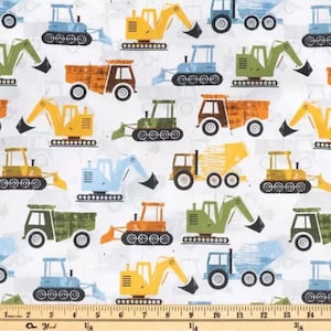May include: A white fabric with a repeating pattern of various construction vehicles. The vehicles are in shades of yellow, blue, green, brown, and orange. The vehicles include dump trucks, excavators, bulldozers, and cement mixers.