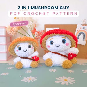 May include: Two plush mushroom figures made of white, orange, and red yarn with embroidered faces and blue eyes. The text 2 IN 1 MUSHROOM GUY PDF CROCHET PATTERN and Low-sew is visible. The figures have brown straps and small red mushroom accessories.
