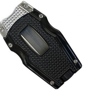 May include: A black and silver cigar cutter with a textured grip and a silver blade. The cutter has a diamond pattern on the top and a black and silver design on the bottom.