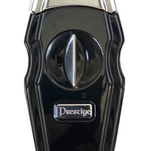 May include: Black and silver cigar cutter and lighter with the word "Prestige" on the front.