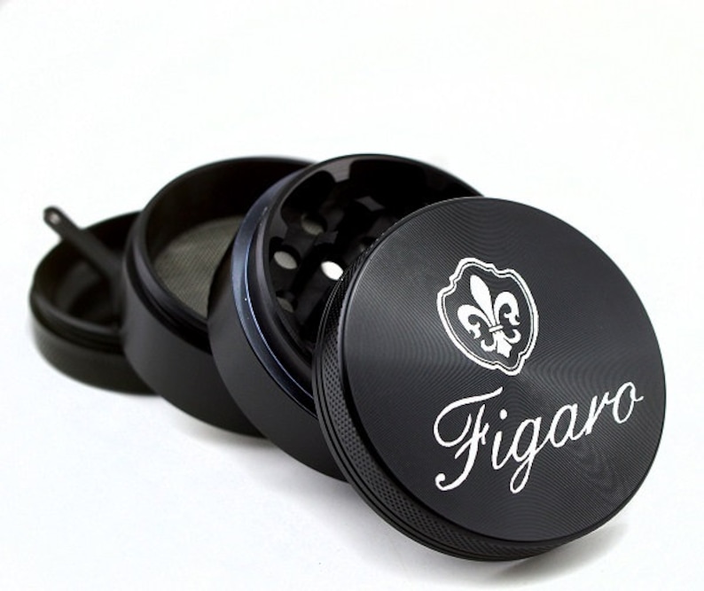 May include: Black metal grinder with a fleur-de-lis design and the word "Figaro" engraved on the side.