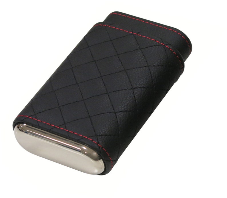 May include: Black leather cigar case with red stitching and a silver metal interior. The case has a quilted pattern.