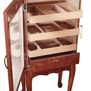 May include: A wooden humidor with a glass door and three drawers. The humidor is on four legs and has a brown finish.