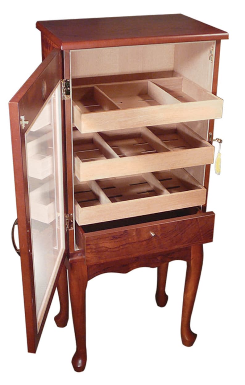 May include: A wooden humidor with a glass door and three drawers. The humidor is on four legs and has a brown finish.