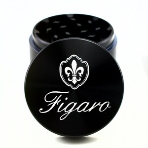 May include: Black metal grinder with a fleur-de-lis design and the word "Figaro" engraved on the lid.