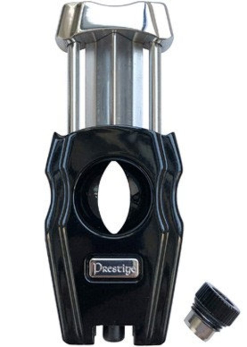 May include: A black and silver cigar cutter with a Prestige logo. The cutter has a guillotine blade and a removable cap.