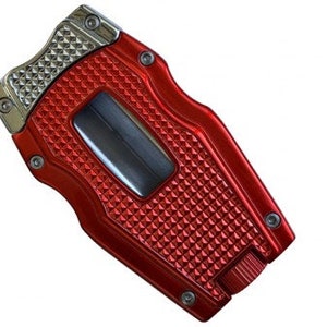 May include: Red metal cigar cutter with a silver top and a diamond pattern. The cutter has a built-in lighter.
