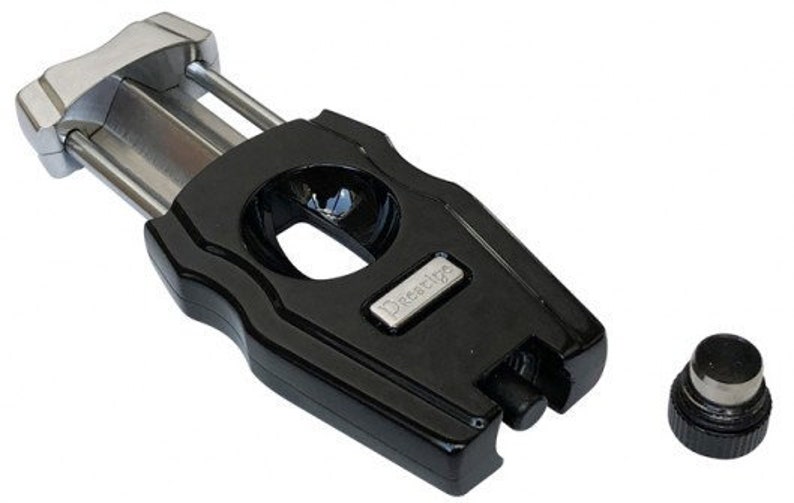 May include: Black cigar cutter with a silver blade and a silver label that says "Xikar 125".