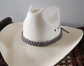 May include: A white cowboy hat with a gray braided band and black accents.