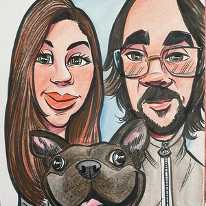 May include: A caricature drawing of a couple with their dog. The woman has long brown hair and is wearing a white shirt. The man has brown hair and is wearing a gray zippered jacket. The dog is a brown and black French Bulldog.
