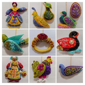 May include: A collection of handmade felt ornaments, including a doll, birds, a ring, a swan, and a rooster. The ornaments feature vibrant colors like yellow, blue, red, and green, with intricate beadwork and embroidery details. Each ornament has a gold string for hanging.
