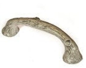 May include: A silver-toned, rustic, twig-shaped cabinet pull with a knot on the end.