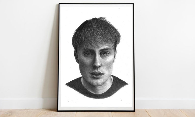 May include: A black and white pencil drawing of a person's face. The person has short, straight hair and is looking directly at the viewer.