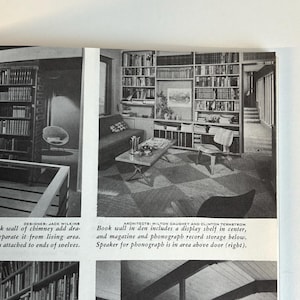 May include: Black and white photograph of a mid-century modern living room with built-in bookshelves. The room features a sofa, coffee table, and a chair. The text in the image reads: "Book wall in den includes a display shelf in center, and magazine and phonograph record storage below."