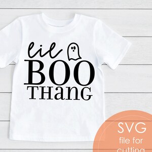 May include: White t-shirt with the phrase "lil BOO Thang" in black script and block letters, with a small ghost graphic. The shirt is a children's size, perfect for Halloween. The image also includes a graphic that says "SVG file for cutting machines PNG file incl."