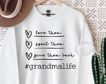 May include: White sweatshirt with black text that reads "love them, spoil them, give them back #grandmalife". The text is in a handwritten font and includes three heart symbols.