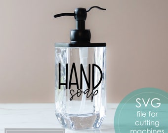 May include: A clear plastic soap dispenser with a black pump and a black vinyl sticker that says "HAND soap".
