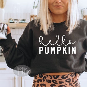 May include: Black sweatshirt with the text "hello pumpkin" in white lettering.