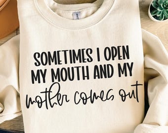 May include: A cream-colored sweatshirt with the text "Sometimes I open my mouth and my mother comes out" printed in black.