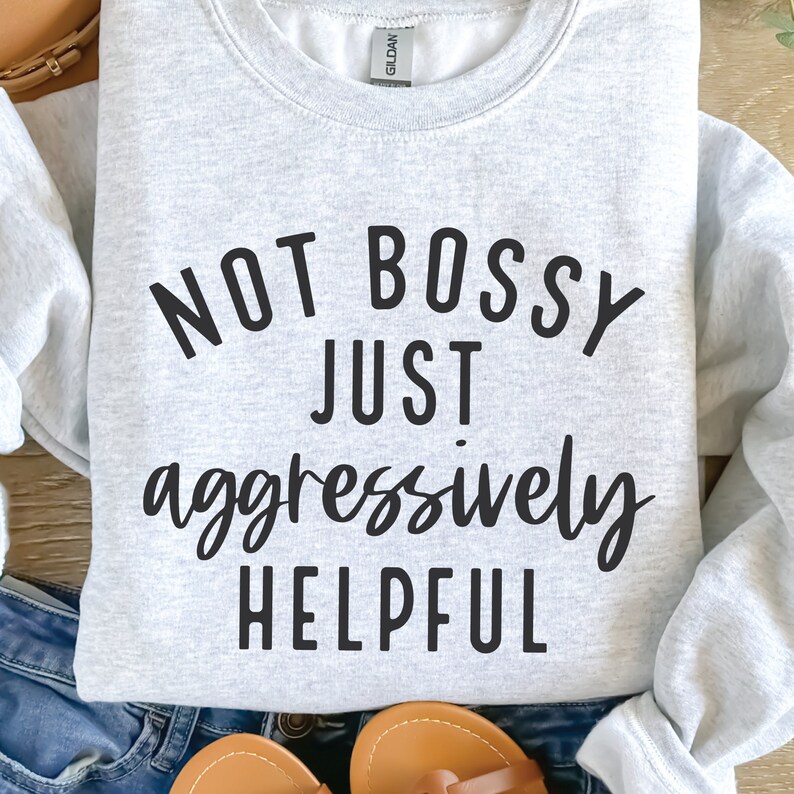 May include: Grey sweatshirt with the text "NOT BOSSY JUST aggressively HELPFUL" printed in black.