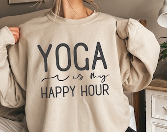 May include: A beige sweatshirt with the text "YOGA is my HAPPY HOUR" printed in black.